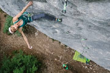 Rock climber midway up rock face