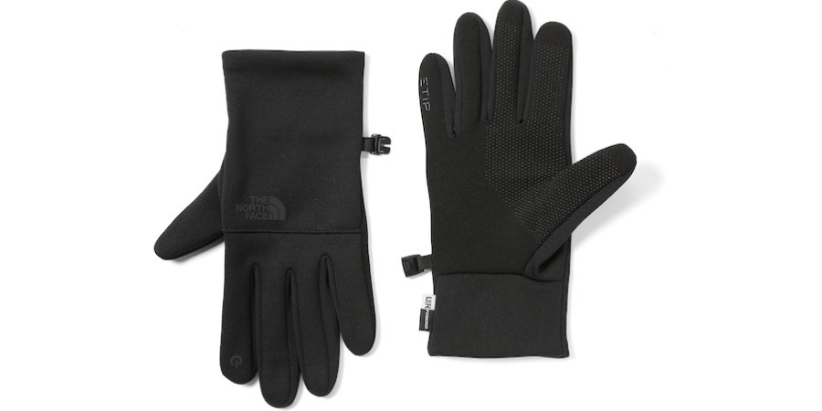 A pair of black The North Face ETip Recycled Gloves, laying flat on a white background