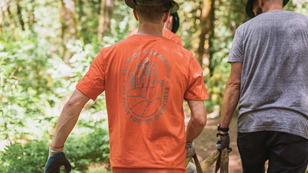 Trail crew team member with REI shirt