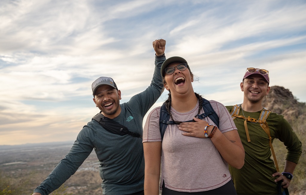 Three hikers laughing