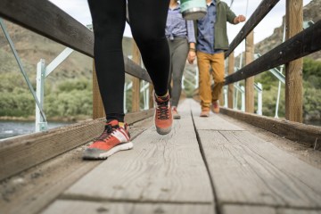 Photo of people walking across a bridge.