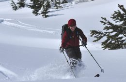 Stacy Gold skiing deep powder and smiling