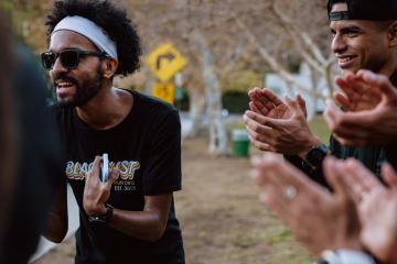A group of runners from BlacklistLA cheer on their teammates