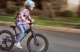 A young cyclist rides the Co-op Cycles REV 20 6-Speed Plus Kids' Bike