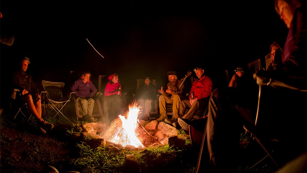 Campers gathered around a campfire