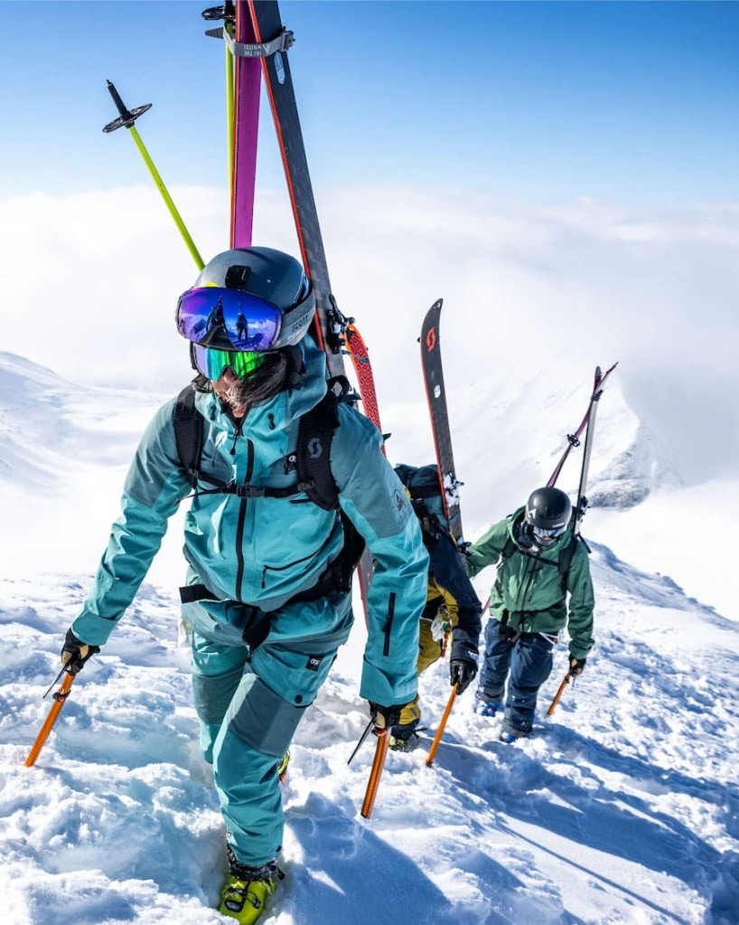 Jackie Paaso and two other skiers bootpack up a snowy ridge.