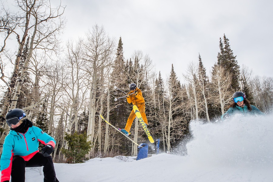 Skiers and snowboarders show off.