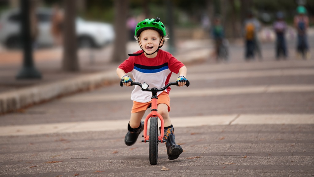 A child rides a 12-inch Co-op Cycles REV 12 kids' balance bike