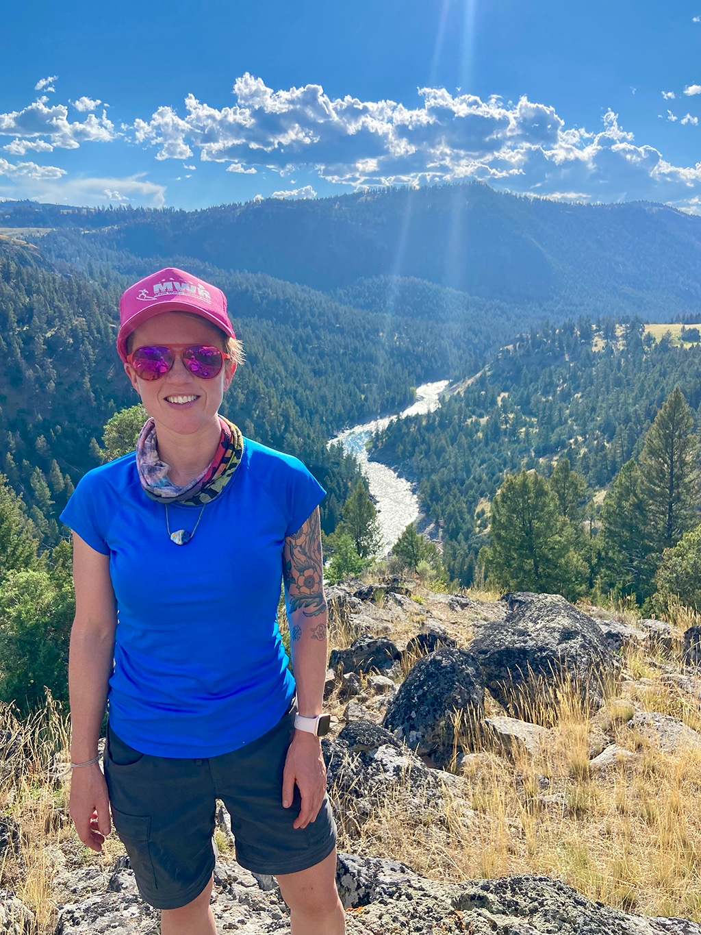 Writer Meghan McCallum stands in front of a scenic view at Yellowstone National Park
