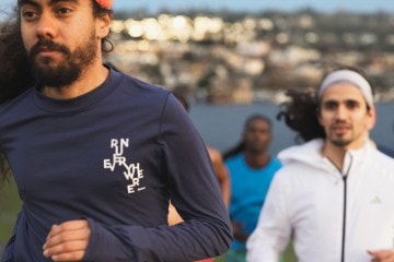 Four people run during an REI-sponsored event, including senior sales manager Alan Ortega.