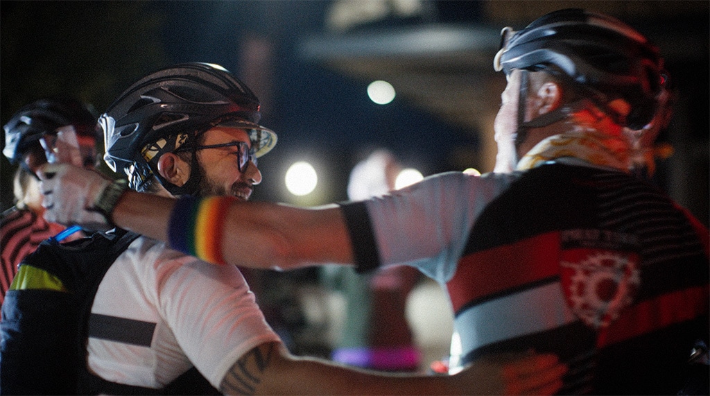 Izzy Sederbaum greets a friend at a cycling event.