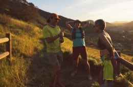 Three runners on a trail, laughing together