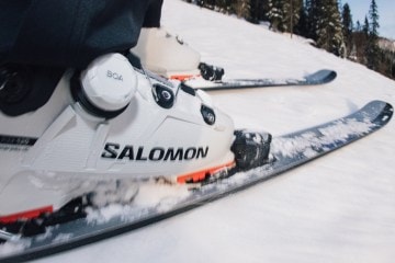 Close up of ski boots on snow.