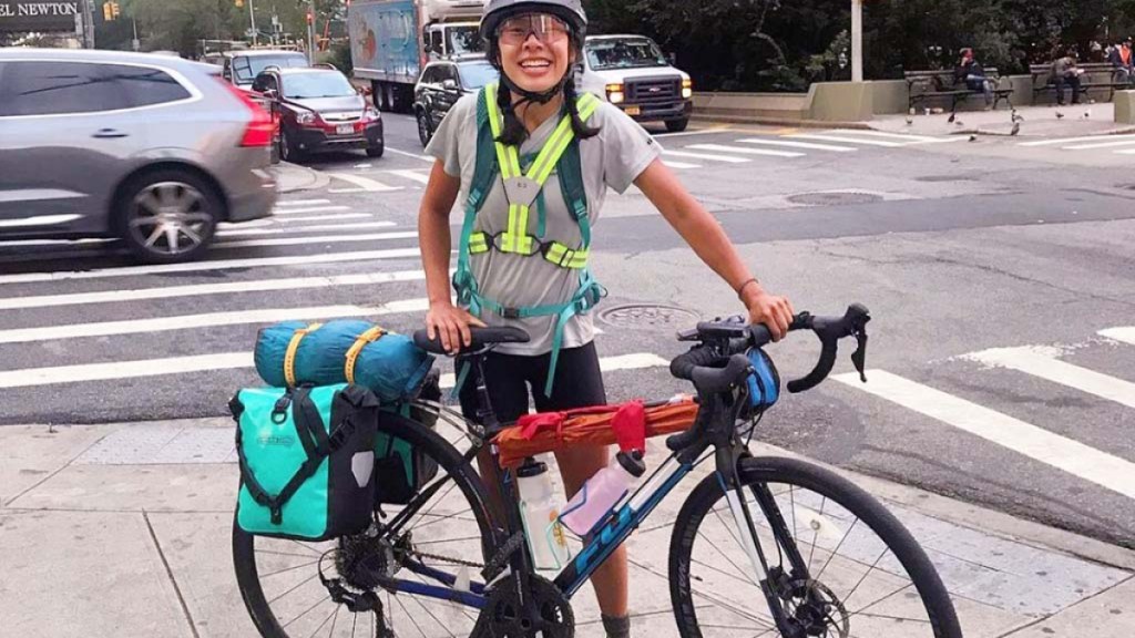 Regina Yan stands next to her bike on a corner in New York City.