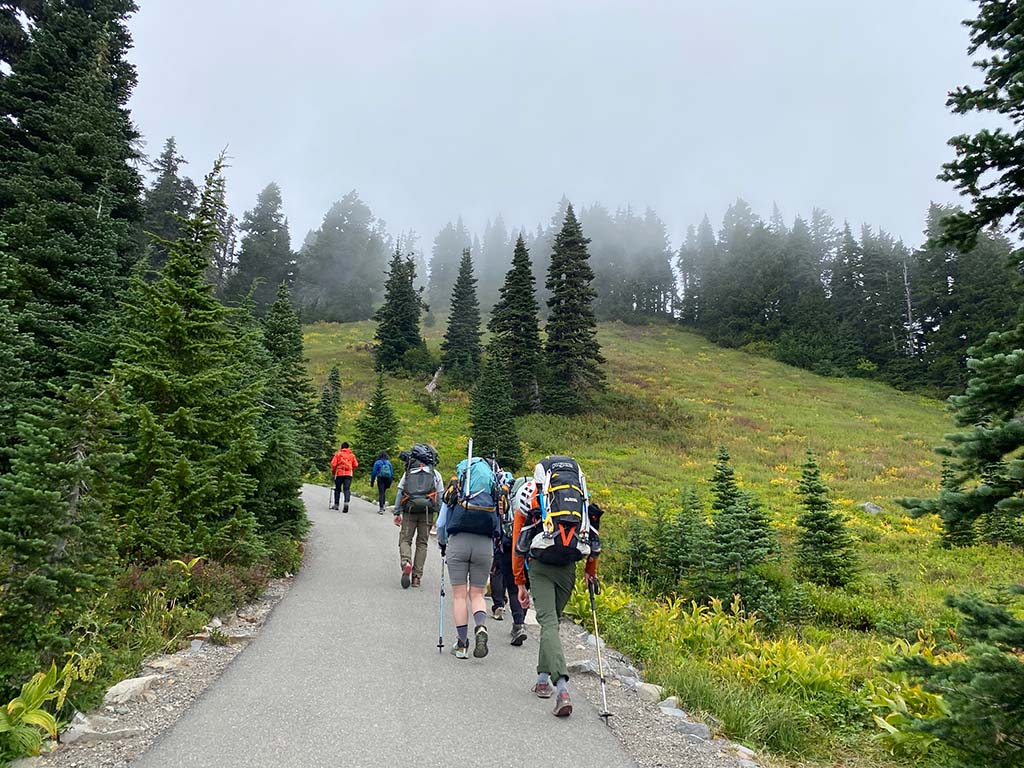 A group of mountaineers headed up a trail to begin a climb.