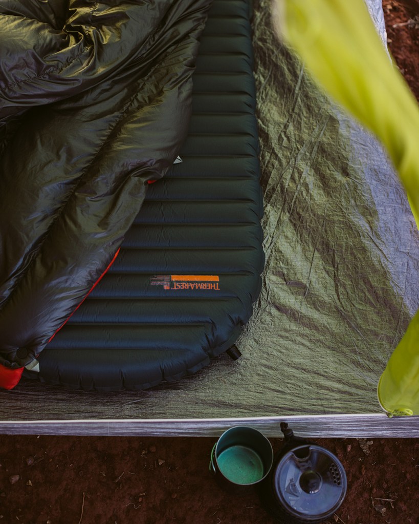 An interior photo of a tent with a sleeping pad and sleeping bag inside.