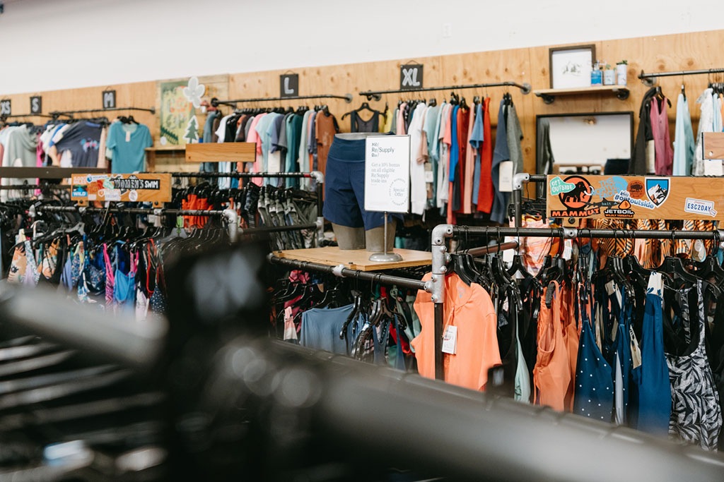 An interior photo of an REI retail store with a Re/Supply display