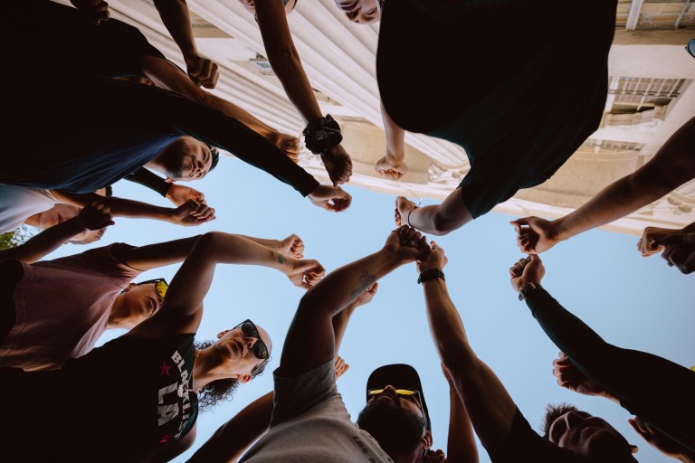 A group of people with their fists raised in the air