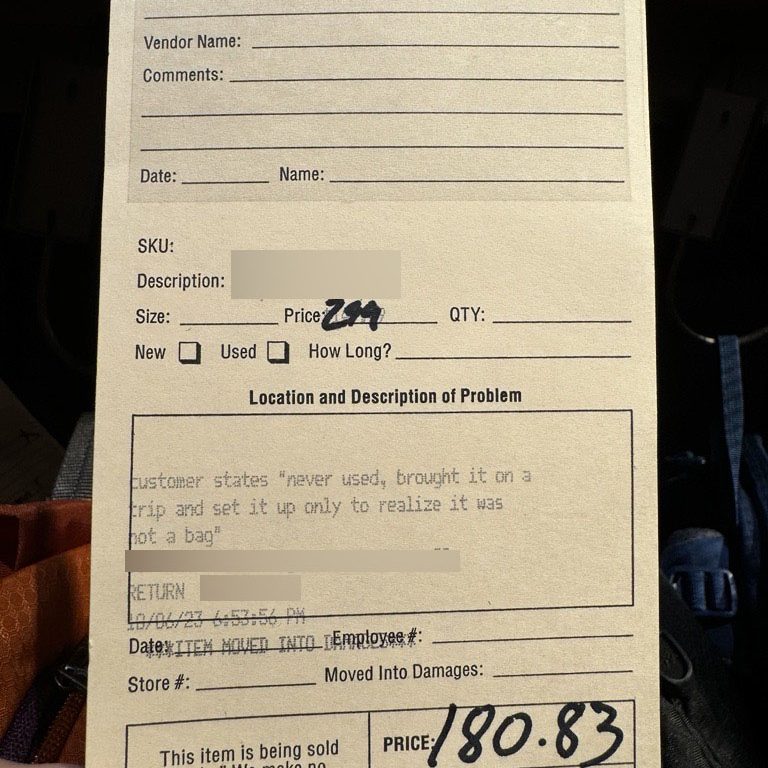 Return tag that reads: "customer states 'never used, brought it on a trip and set it up only to realize it was not a bag'"