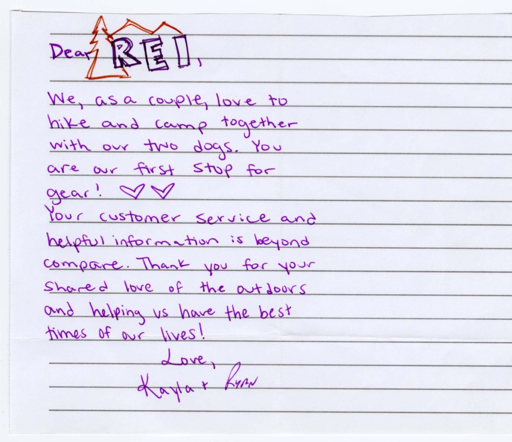 A note written in purple pen on lined paper, and featuring a hand-drawn REI logo at the top.