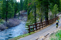A person bikes along a scenic bike and pedestrian path in North Lake Tahoe.