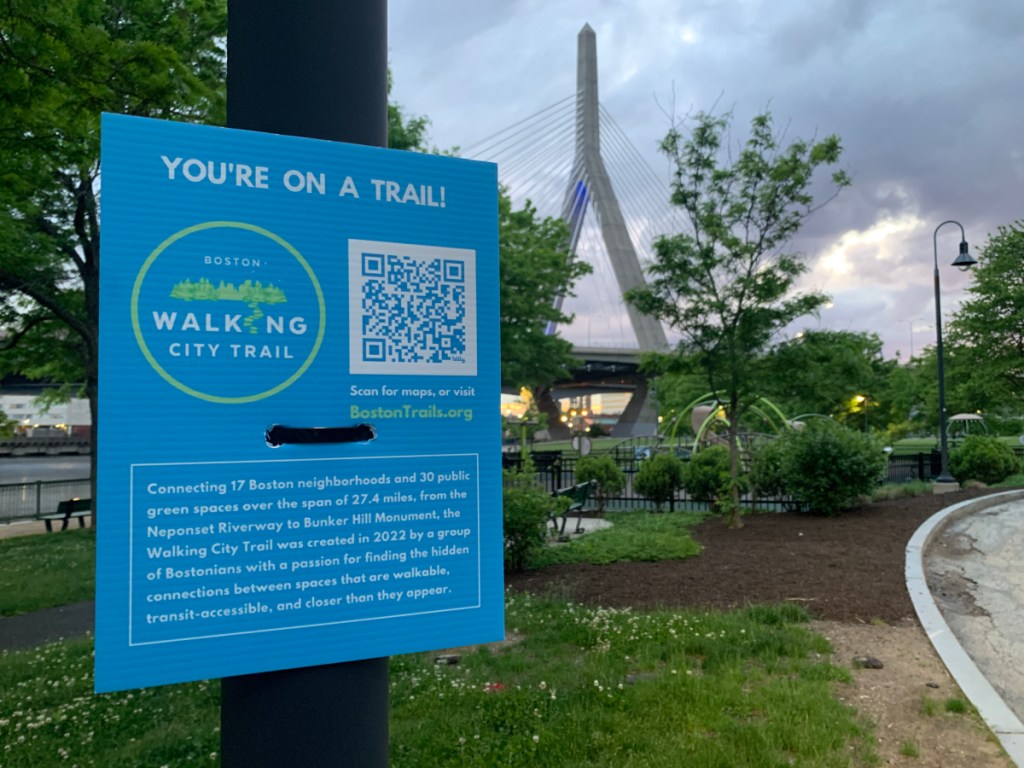 A sign on a post that says "You are on a trail," to inform urban hikers that they are on the Walking City Trail