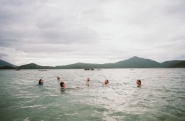 Photo of six people swimming in a body of water.