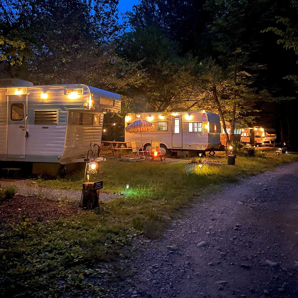 A nighttime view of the glamping RV park Boheme Retreats