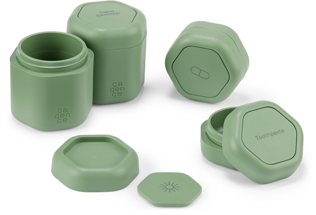 Several olive green recycled plastic Cadence Capsules arranged in a circular pattern, some with lids on and some without lids.