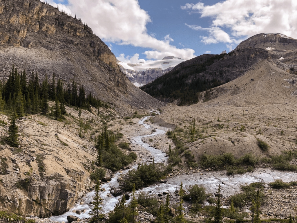 A photo of the Canadian rockies, with a river passing between two mountainous outcroppings