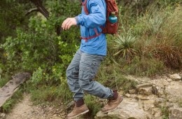 A solo hiker bounds down a rocky trail.