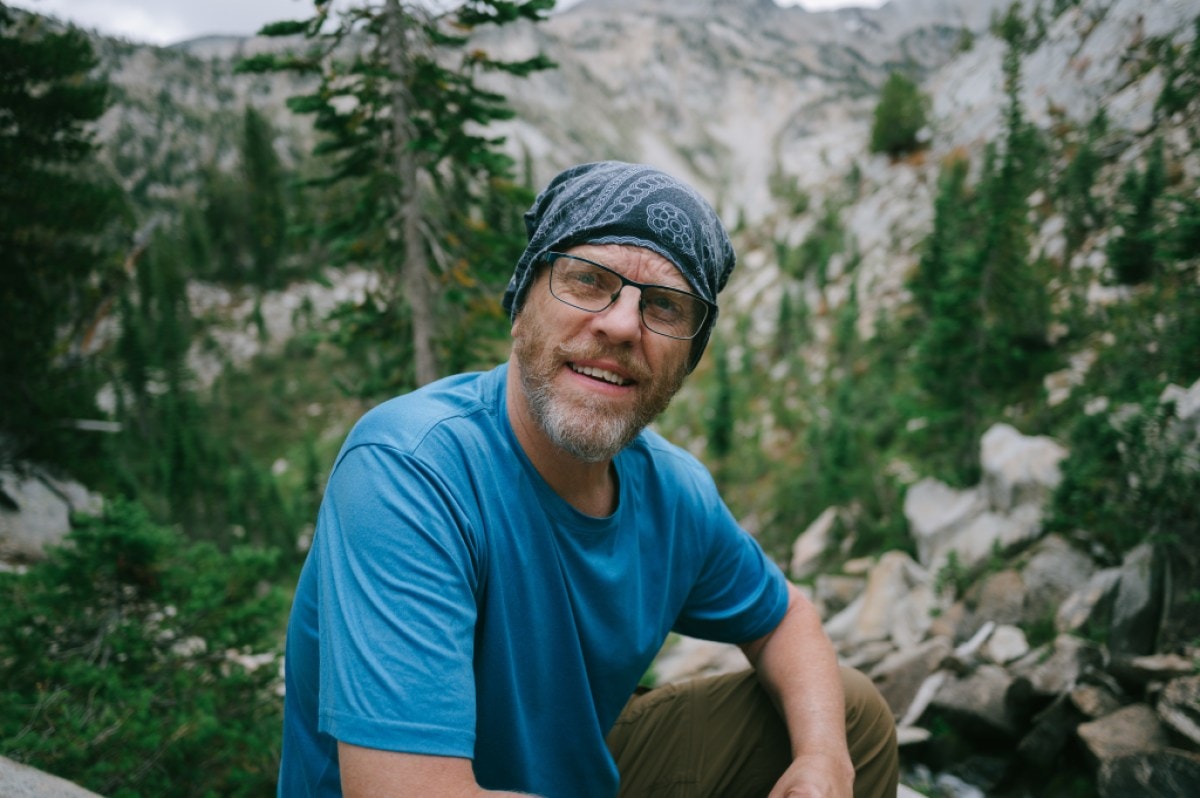 A portrait of a hiker wearing a bandana on his head
