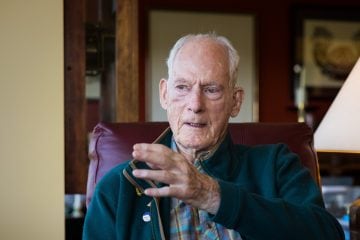 Jim Whittaker gestures as he tells more mountaineering stories in his home.