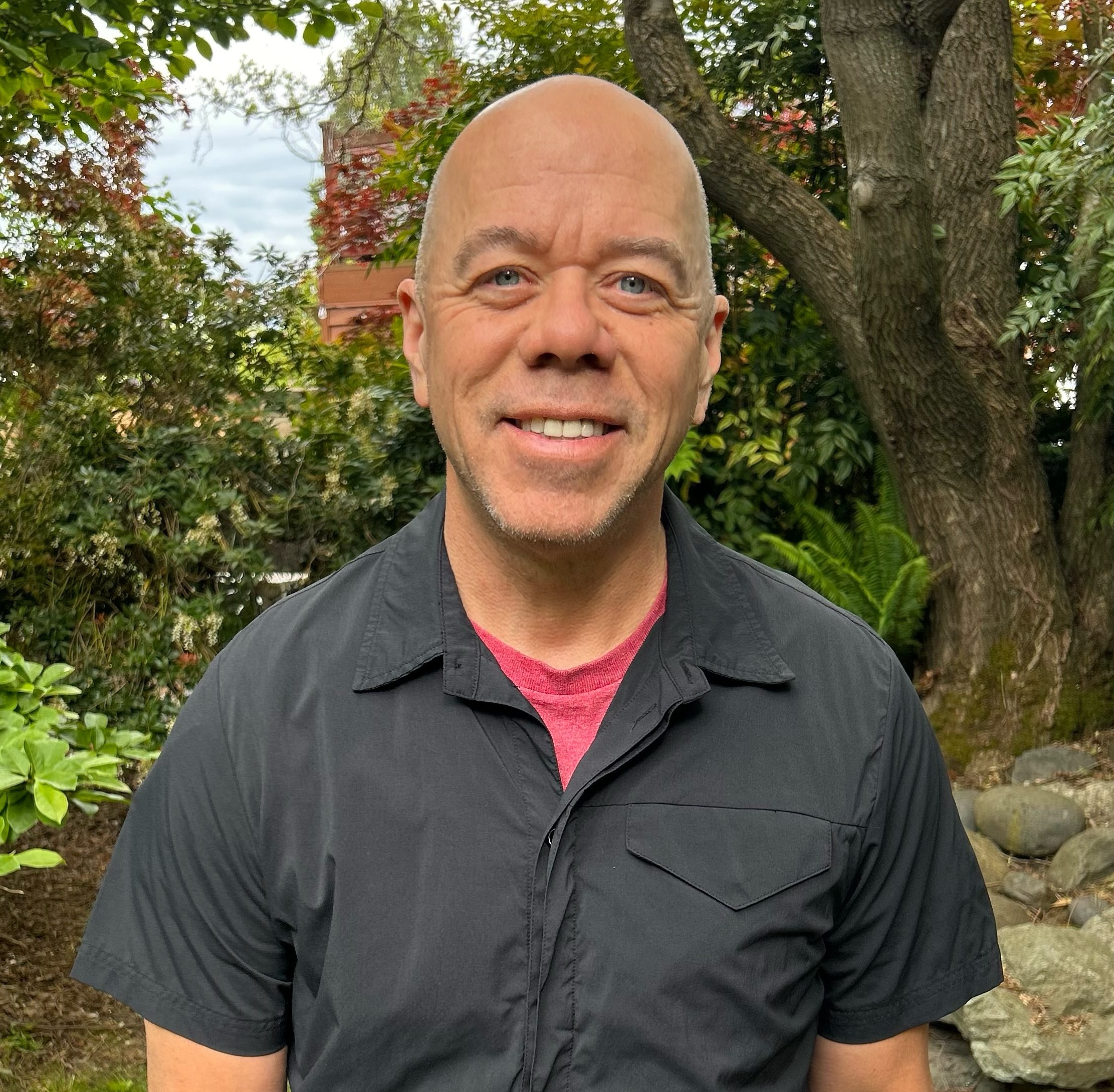 portrait of a man wearing a short-sleeve black shirt