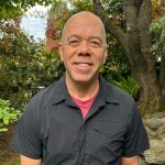 portrait of a man wearing a short-sleeve black shirt