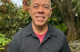 portrait of a man wearing a short-sleeve black shirt
