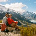 Picture of the authors, MAK and Owen, posing together on a rock in front of a mountainous backdrop.