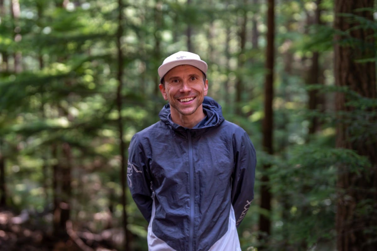 Profile of professional climber Jonathan Siegrist smiling amid trees