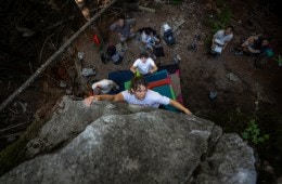 A participant boulders while professional climber Hamish McArthur spots her at the Arc'teryx Climb Academy in Squamish, British Columbia