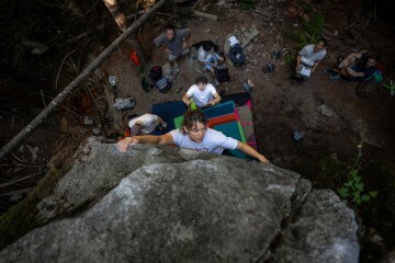 A participant boulders while professional climber Hamish McArthur spots her at the Arc'teryx Climb Academy in Squamish, British Columbia