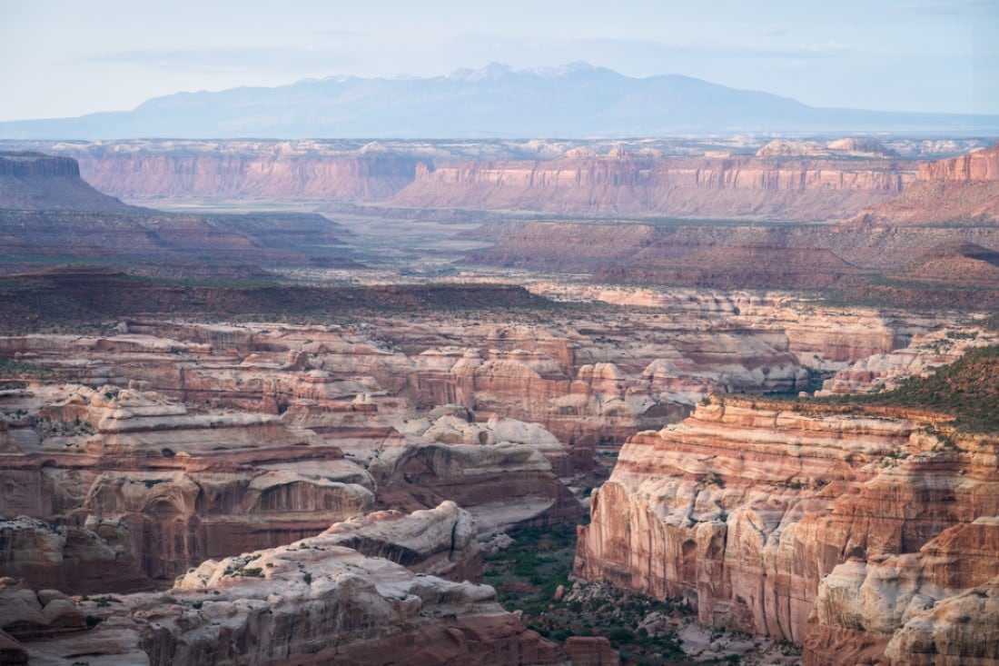 A photo from an elevated location looking out on some rocky plateaus and buttes.