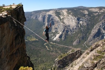 Breannah Yeh slacklining between two mountains.