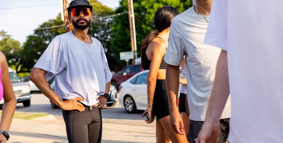 A runner in the REI Co-op Swifltand Grid Running Top in white.