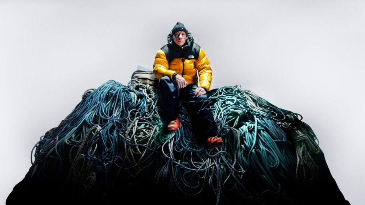 Ski mountaineer Jim Morrison wears the yellow and black iconic Nuptse down jacket on top of a pile of ropes