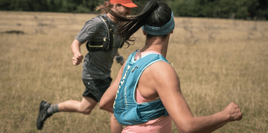 Two runners in Nathan running hydration packs