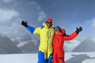 Rob Lea and Caroline Gleich on top of a mountain for Wild Ideas Worth Living podcast