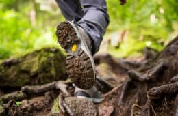 The a person walking through a forest in a hiking boot with a Vibram Megagrip sole.