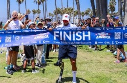 Mohamed Lahna running through a finish line ribbon. For REI's Wild Ideas Worth Living podcast.