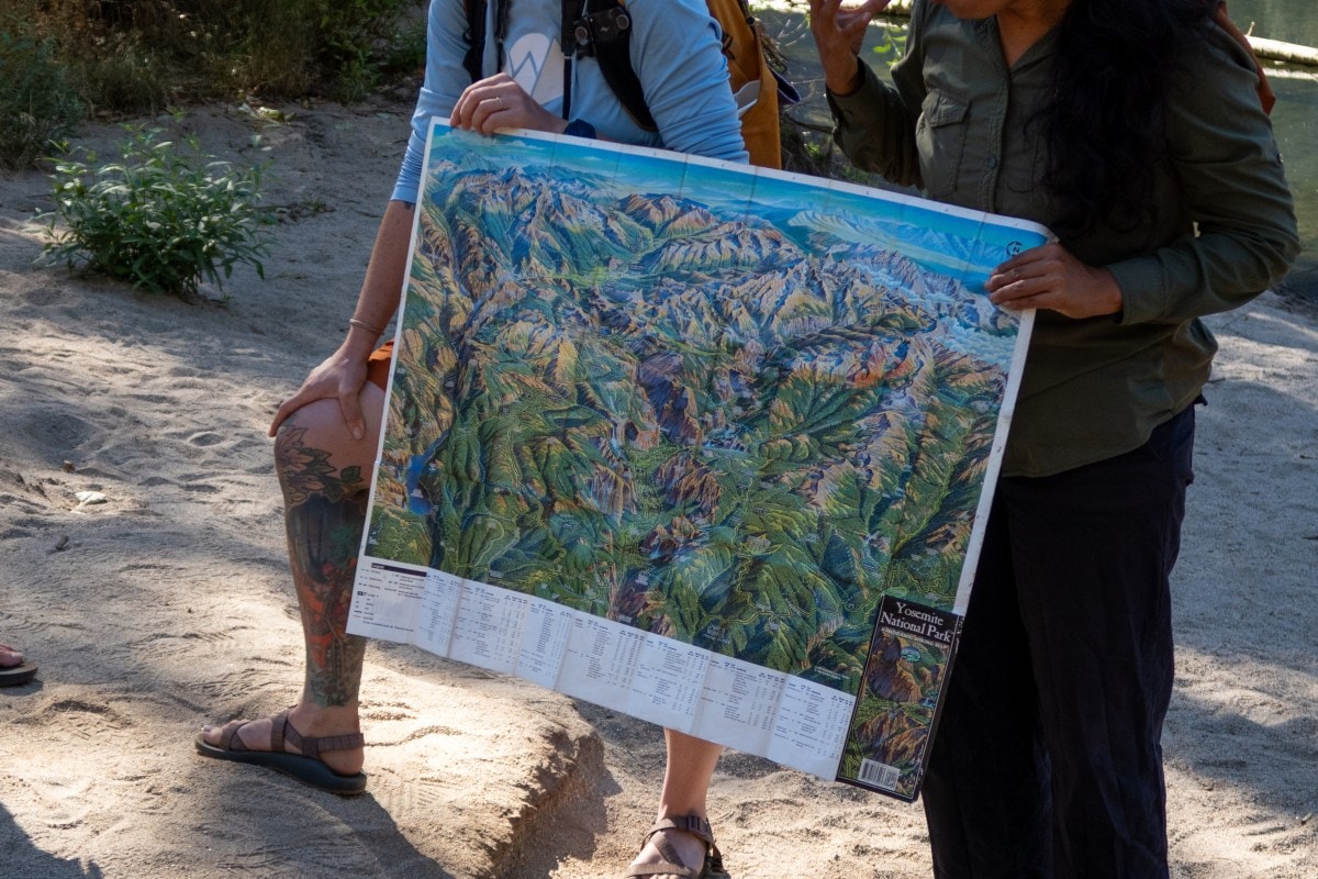 Two adults hold a map of Yosemite National Park