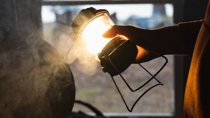 A camper uses the Goal Zero Lighthouse 600 to illuminate his hut.